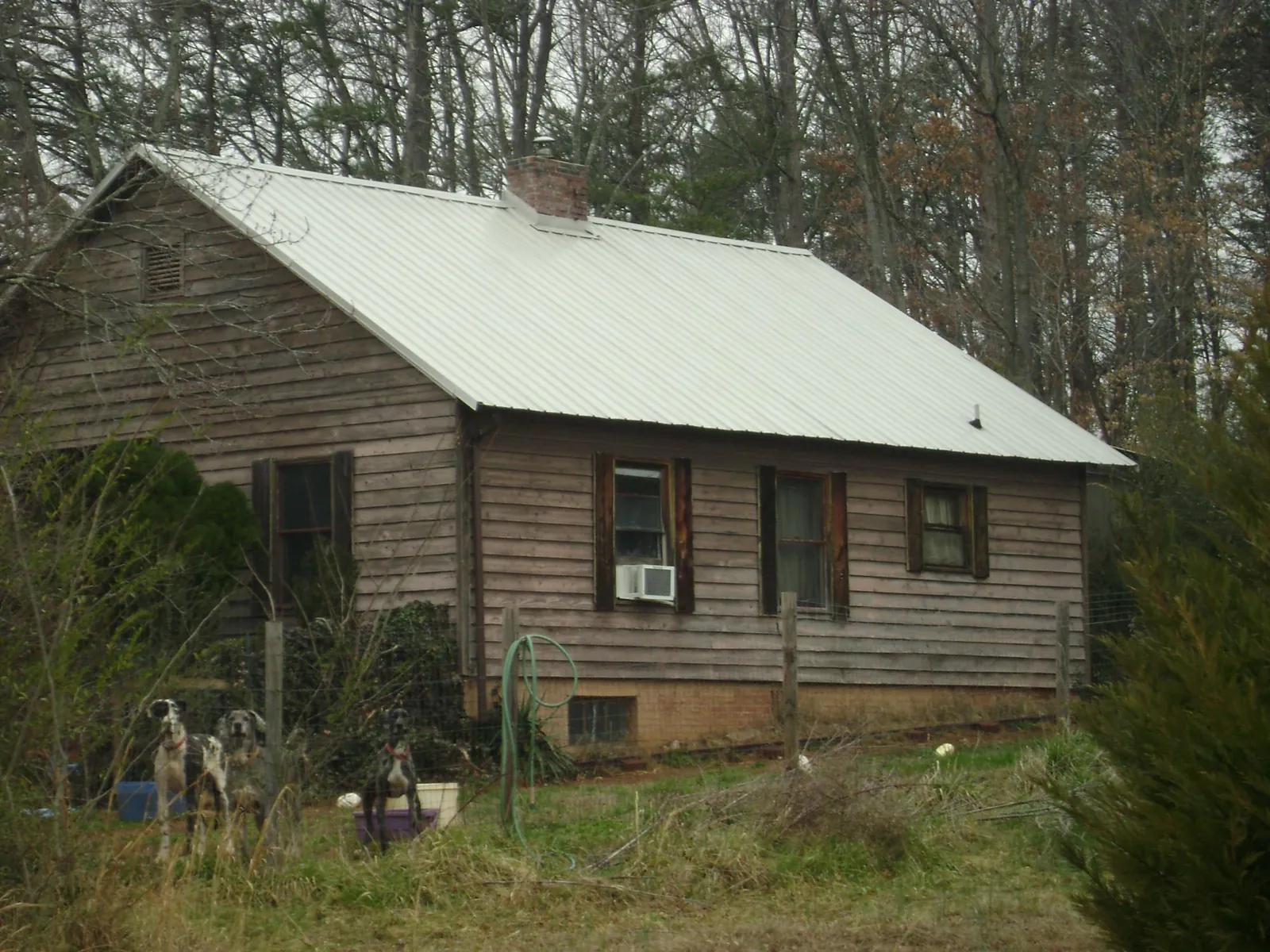 White metal roof on an old wood sided farmhouse, from a Metal Roof Installation job in Maryknoll